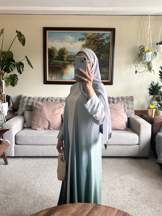 Elegant green abaya showcasing modest clothing style for contemporary fashion lovers.