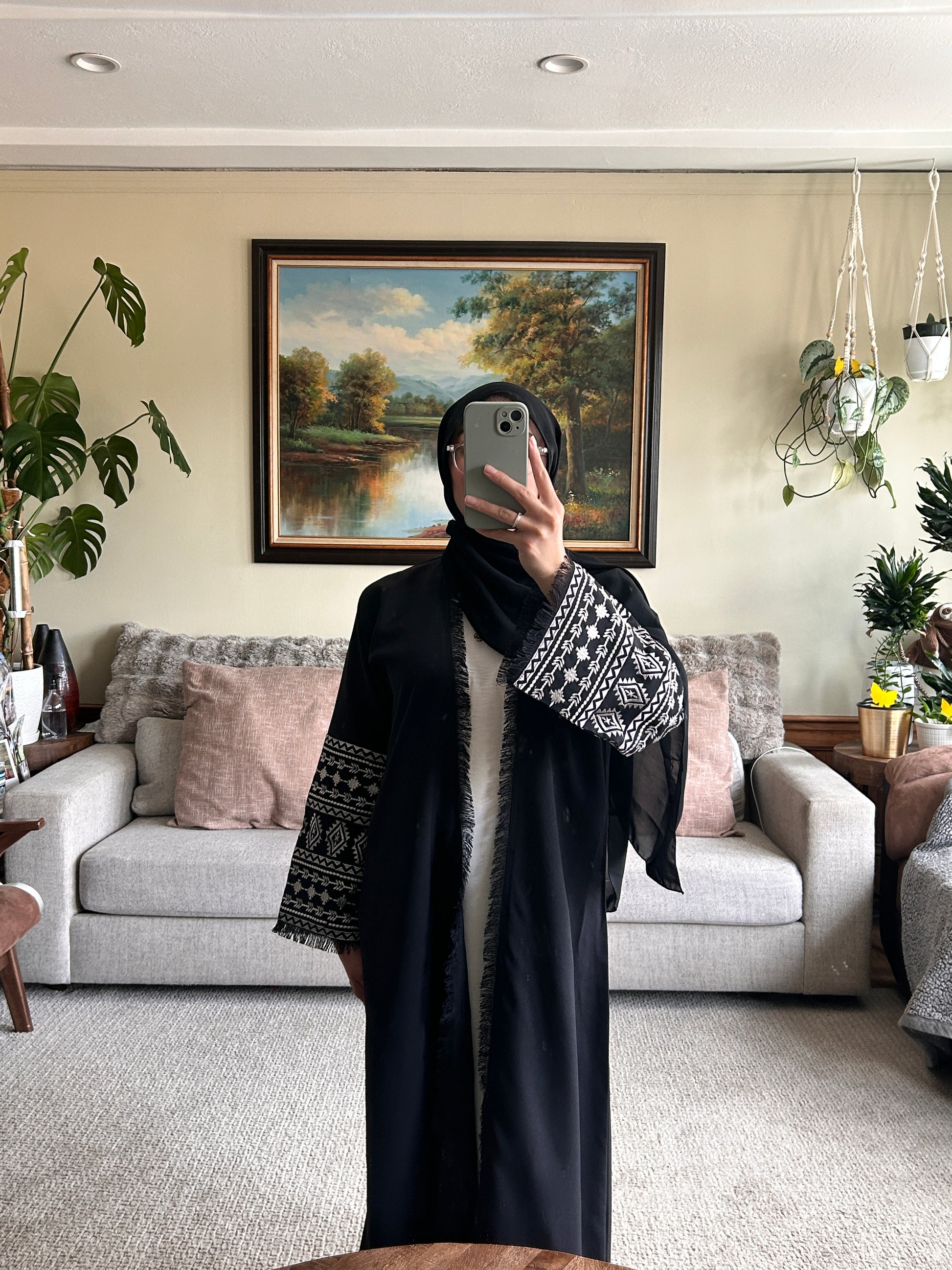 Stylish black embroidered abaya featuring intricate designs for a sophisticated look.