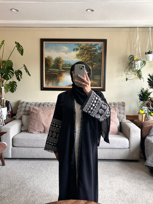 Stylish black embroidered abaya featuring intricate designs for a sophisticated look.